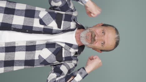 Vertical-video-of-Old-man-clapping-excitedly-to-camera.
